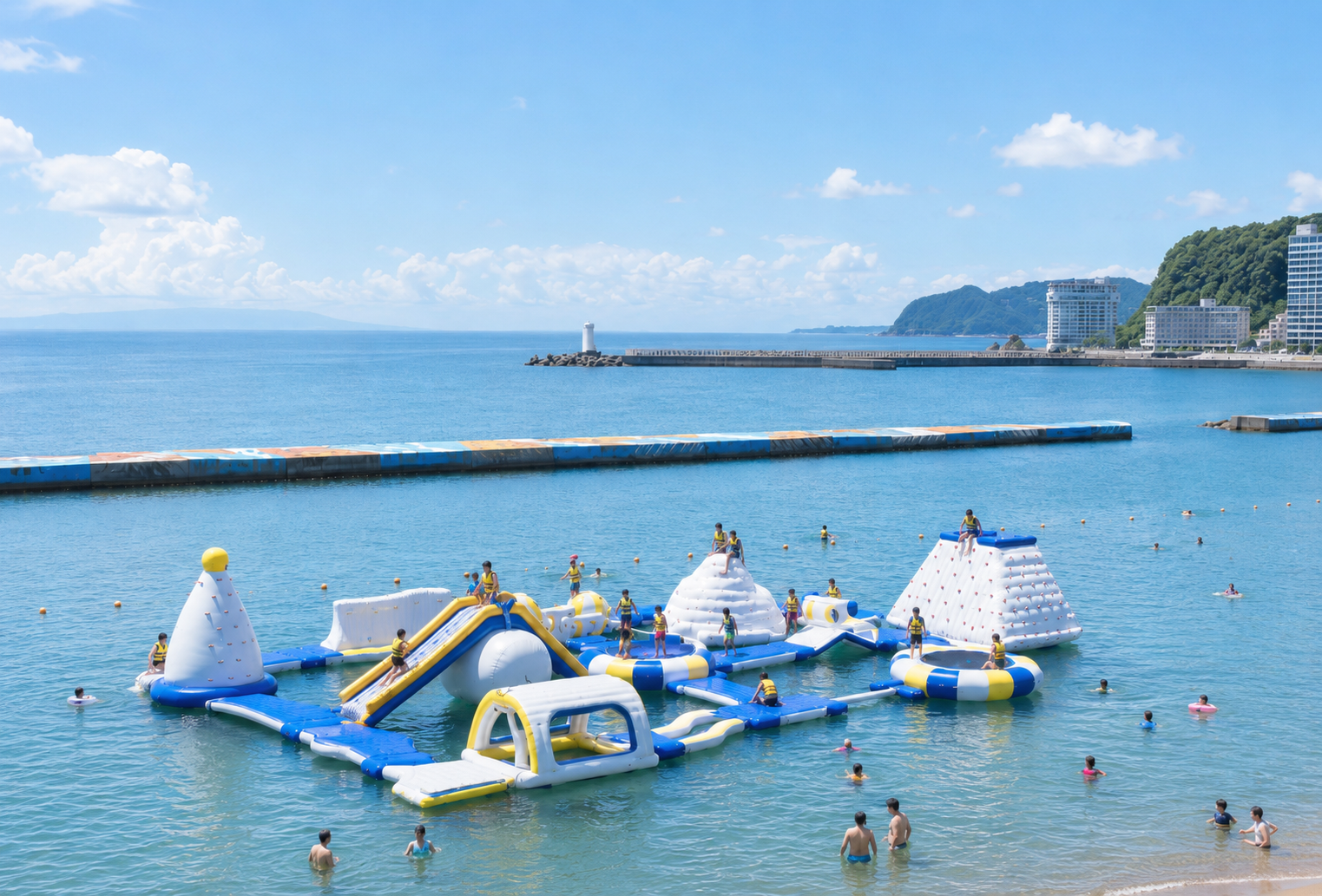 熱海サンビーチのウォーターパーク。海上に浮かぶエア遊具で遊ぶ子供たち